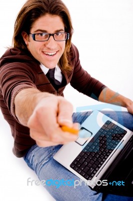 Side Pose Of Smiling Man With Laptop And Pencil Stock Photo