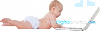 Side View Of Cute Baby Boy Using Laptop Stock Photo