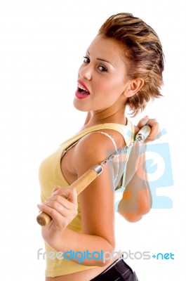 Side View Of Young Woman With Nunchaku Stock Photo