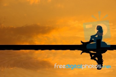 Silhouette Asian Woman Sitting And Looking For Something On The Stock Photo