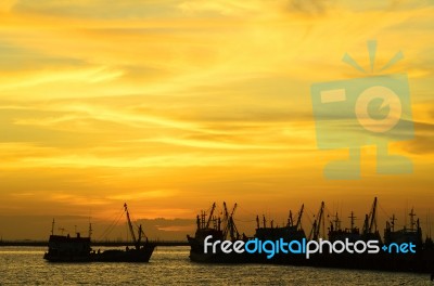Silhouette Boat At Sunset Stock Photo