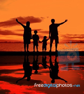 Silhouette Family At Beach Stock Photo