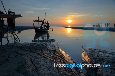 Silhouette Fisherman Is Standing On Fishing Boat Stock Photo