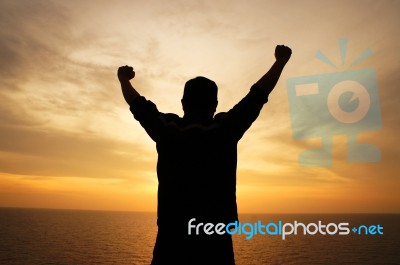 Silhouette Man Hand Raising Up Stock Photo