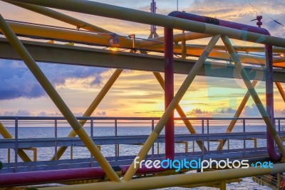 Silhouette Of Structure Of The Bridge In Sun Set At The Sea Stock Photo