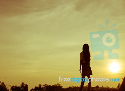 Silhouette Of Woman Praying Over Beautiful Sky Background Stock Photo