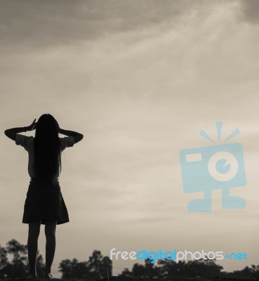 Silhouette Of Woman Praying Over Beautiful Sky Background Stock Photo