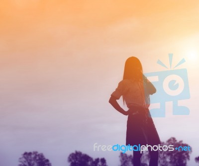 Silhouette Of Woman Praying Over Beautiful Sky Background Stock Photo
