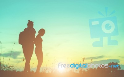 Silhouette Of Woman Praying Over Beautiful Sky Background Stock Photo
