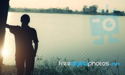 Silhouette Of Woman Praying Over Beautiful Sky Background Stock Photo