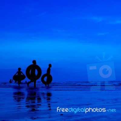 Silhouette People At Beach Stock Photo