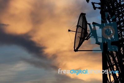 Silhouette Satellite Communication Tower Poles On Sunset Stock Photo