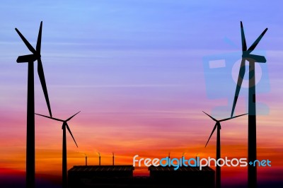 Silhouette Wind Turbine Generator With Factory Emissions Of Carb… Stock Photo