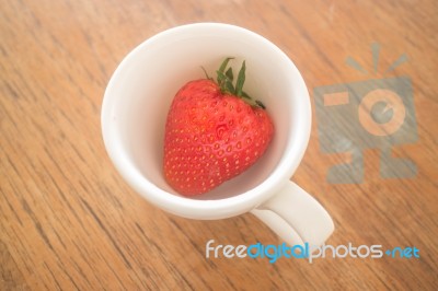 Single Fresh Ripe Strawberry In White Mug Stock Photo