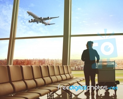 Single Woman Sitting In Airport Terminal And Passenger Plane Flying Outdoor For Traveling Theme Stock Photo
