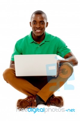 Sitting African Guy Using Laptop Stock Photo