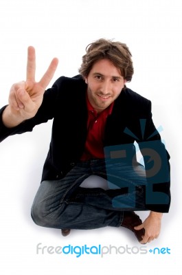 Sitting Man Showing Peace Sign Stock Photo