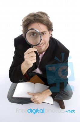 Sitting Man With Diary And Lens Stock Photo