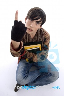 Sitting Student Showing Finger Stock Photo