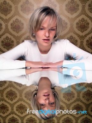 Sitting Young Woman With Reflection Stock Photo