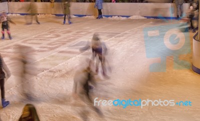 Skaters Moving On The Ice Rink Stock Photo