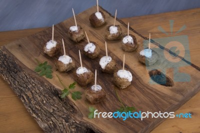 Skewers Of Meat On Wooden Cutting Board Stock Photo