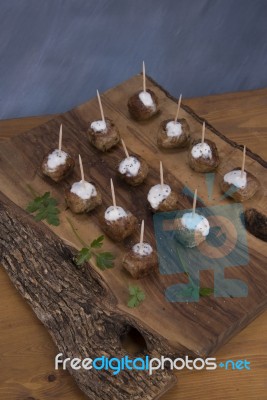 Skewers Of Meat On Wooden Cutting Board Stock Photo