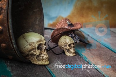Skull In A Bucket Of Water On Wooden Background Stock Photo