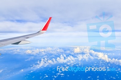 Sky And Clouds. View From The Window Of An Airplane Flying In Th… Stock Photo