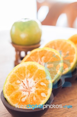 Slice Of Fresh Orange In Wooden Tray Stock Photo