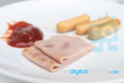 Sliced Ham And Sausage On White Dish Stock Photo