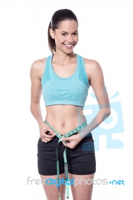 Slim Young Lady Measuring Her Waist Stock Photo