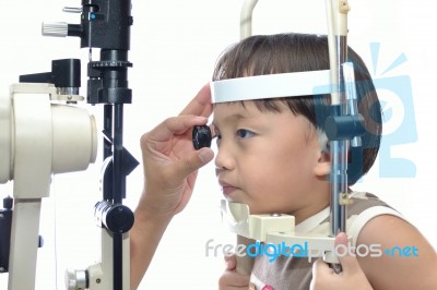 Small Boy With Slit Lamp Microscope Stock Photo