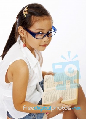 Small Girl Reading Text Book Stock Photo