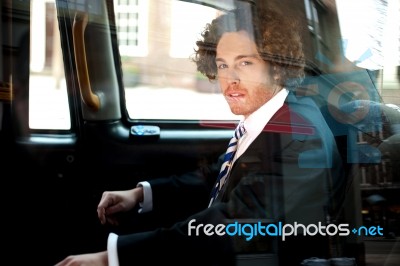 Smart Business Executive Inside Taxi Cab Stock Photo