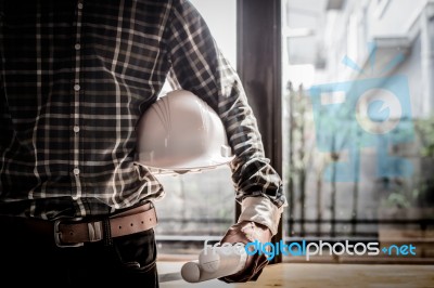 Smart Businessman Holding Construction Helmet And Blueprints In Stock Photo