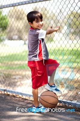 Smart Kid Posing With Basketball Stock Photo