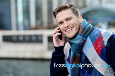 Smart Young Man Talking Via Cell Phone Stock Photo