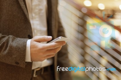 Smartphone In Hand Of Businessman Stock Photo