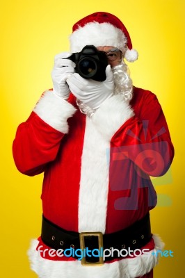 Smile Please! Santa Capturing A Perfect Frame Stock Photo