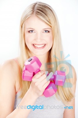 Smiled Woman Holding Two Weights Stock Photo