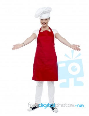 Smiling Aged Lady Chef Gesturing Stock Photo