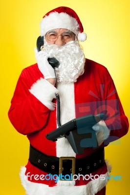 Smiling Aged Santa Attending Phone Call Stock Photo