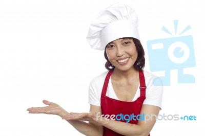 Smiling Asian Female Chef Gesturing Stock Photo