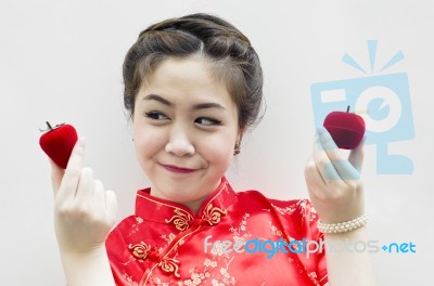 Smiling Beautiful Chinese Woman Holding A Strawberry And An Appl… Stock Photo