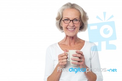 Smiling Bespectacled Old Lady Drinking Coffee Stock Photo