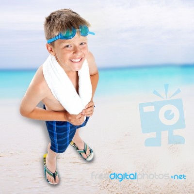 Smiling Boy Standing On Beach Background Stock Photo