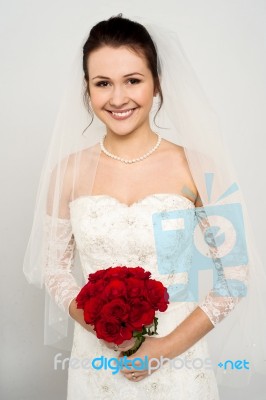 Smiling Bride With A Rose Bouquet Stock Photo