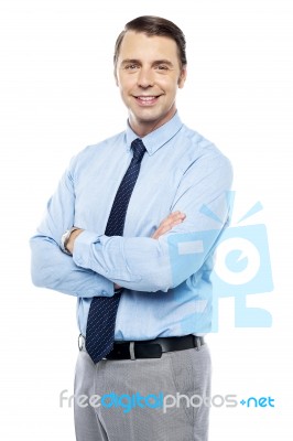 Smiling Business Representative Posing, Arms Folded Stock Photo