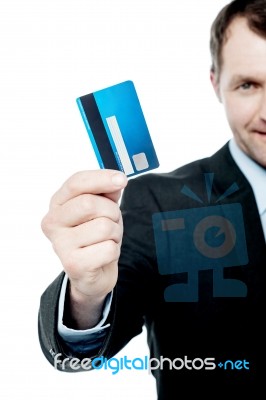 Smiling Businessman Holding Credit Card Stock Photo